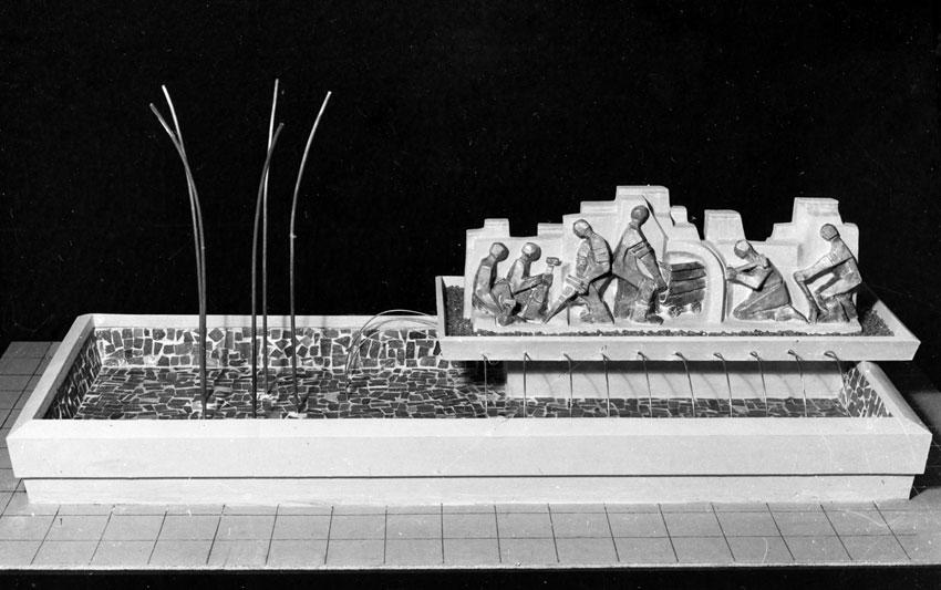 Lily SACHS - Model for fountain outside "Edura" - panel of bronze figures depicting a mining scene against concrete background, jets of water at left
